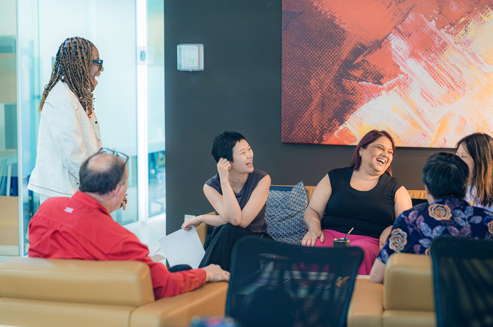 People laughing together at the fireplace lounge.