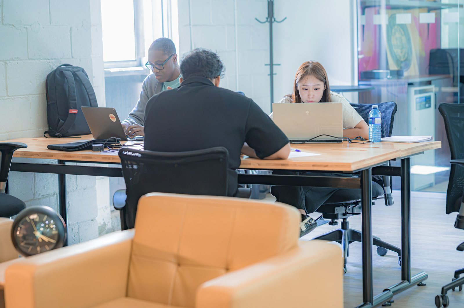 People working hard together at a desk, planning a pitch.